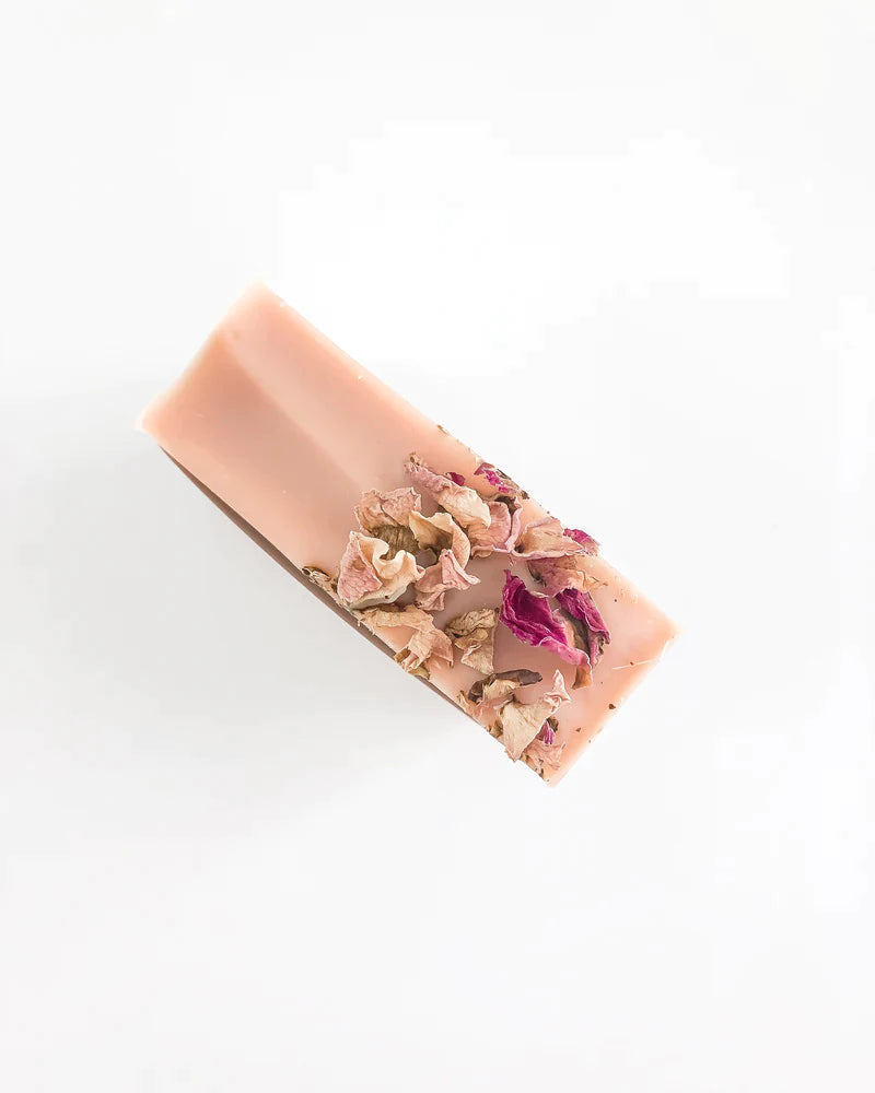 Dried rose petals on top of a pink clay bar soap made naturally for face and body by Agha Studio.