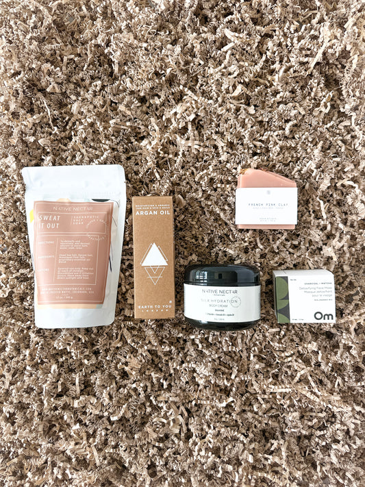 Care package with natural bath salt and body lotion from Native Nectar Botanicals, matcha face mask from Om Organics, handmade soap from Agha Studio, jojoba oil from Earth to You for self-care or as a gift set for a loved one.