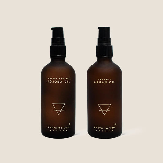 A duo set of organic Argan hair oil and jojoba oil from Earth To You.