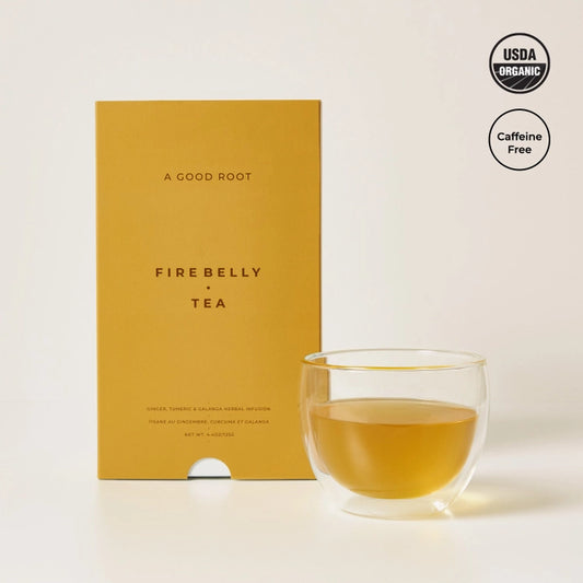 Cup of organic herbal tea by Firebelly Tea made from roots of ginger, turmeric, galangal.