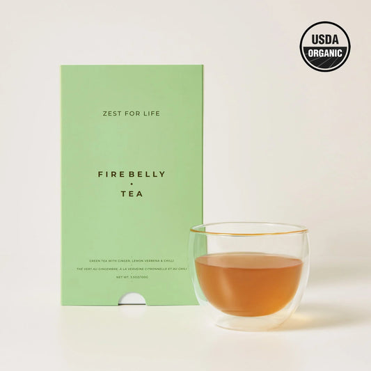 Cup of organic green tea by Firebelly Tea made with lemon, ginger, cardamom, turmeric, and chili.