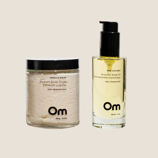 A pair of body scrub and body oil from Om Organics skincare.