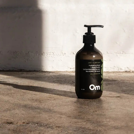 The bottle of a natural hand and body lotion in lime and clary sage scent by Om Organics.