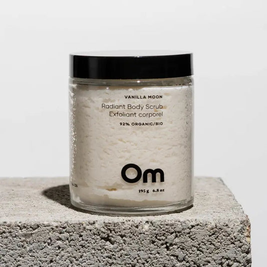 A jar of body scrub with black lid showing the white alt scrub in the jar by Om Organics.