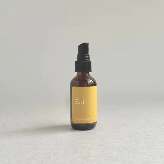 A bottle of linen and room spray made with essential oils of vetiver, sweet orange, and clove by Species by the Thousands.