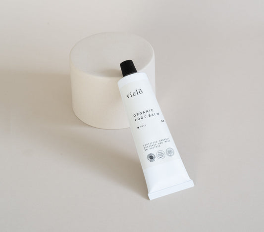 A moisturizing foot balm made with organic ingredients in a minimalistic tube design by vielö.