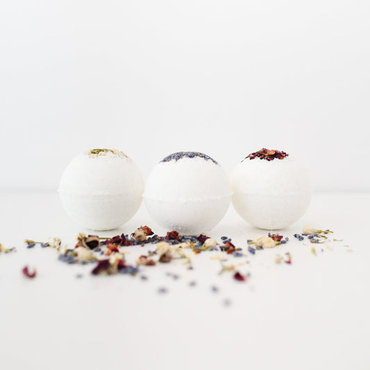 A set of bath bombs handcrafted in shape of a ball topped with natural dried rose petals and lavender. 